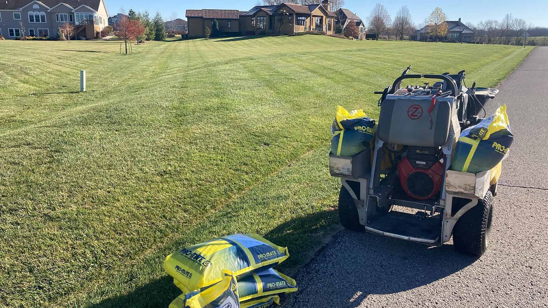 Lawn care equipment next to a green lawn in Olathe, KS.